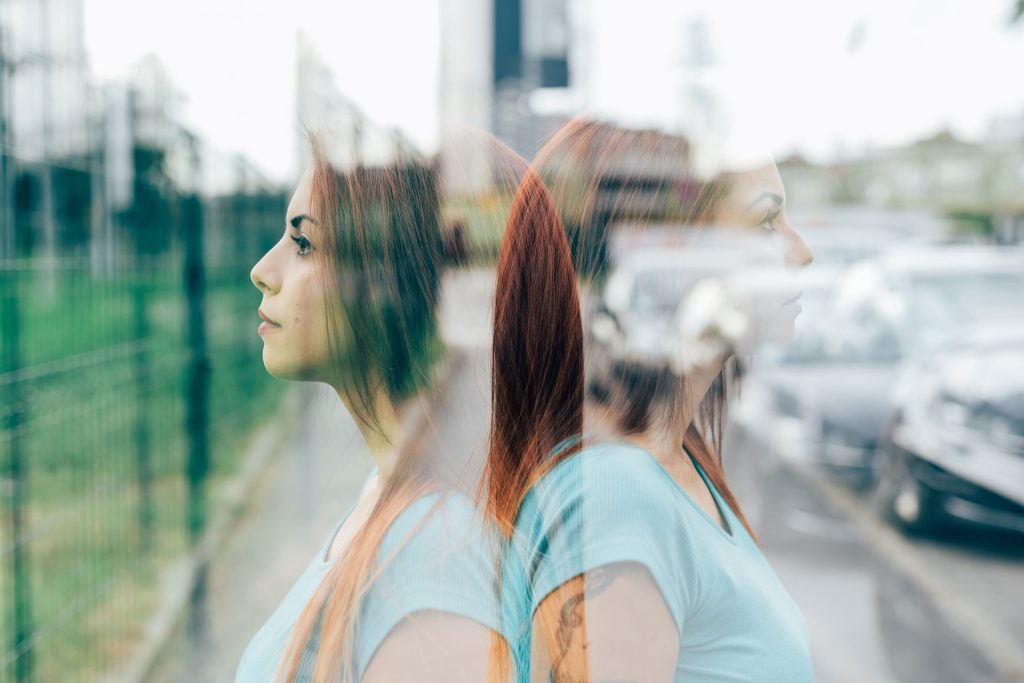 Double exposure photo of a red head woman.