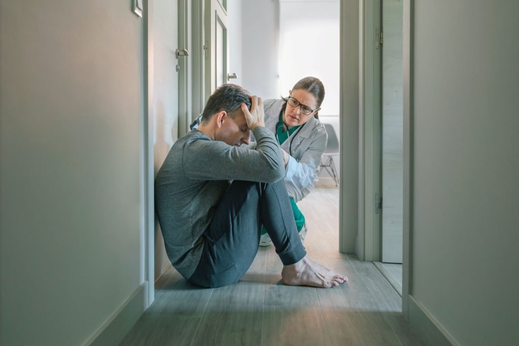 Psychiatrist calming down his patient.